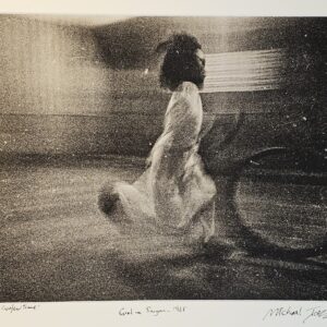 South Vietnam street girl playing with hoop just before dusk curfew bell tolls by Michael Joseph