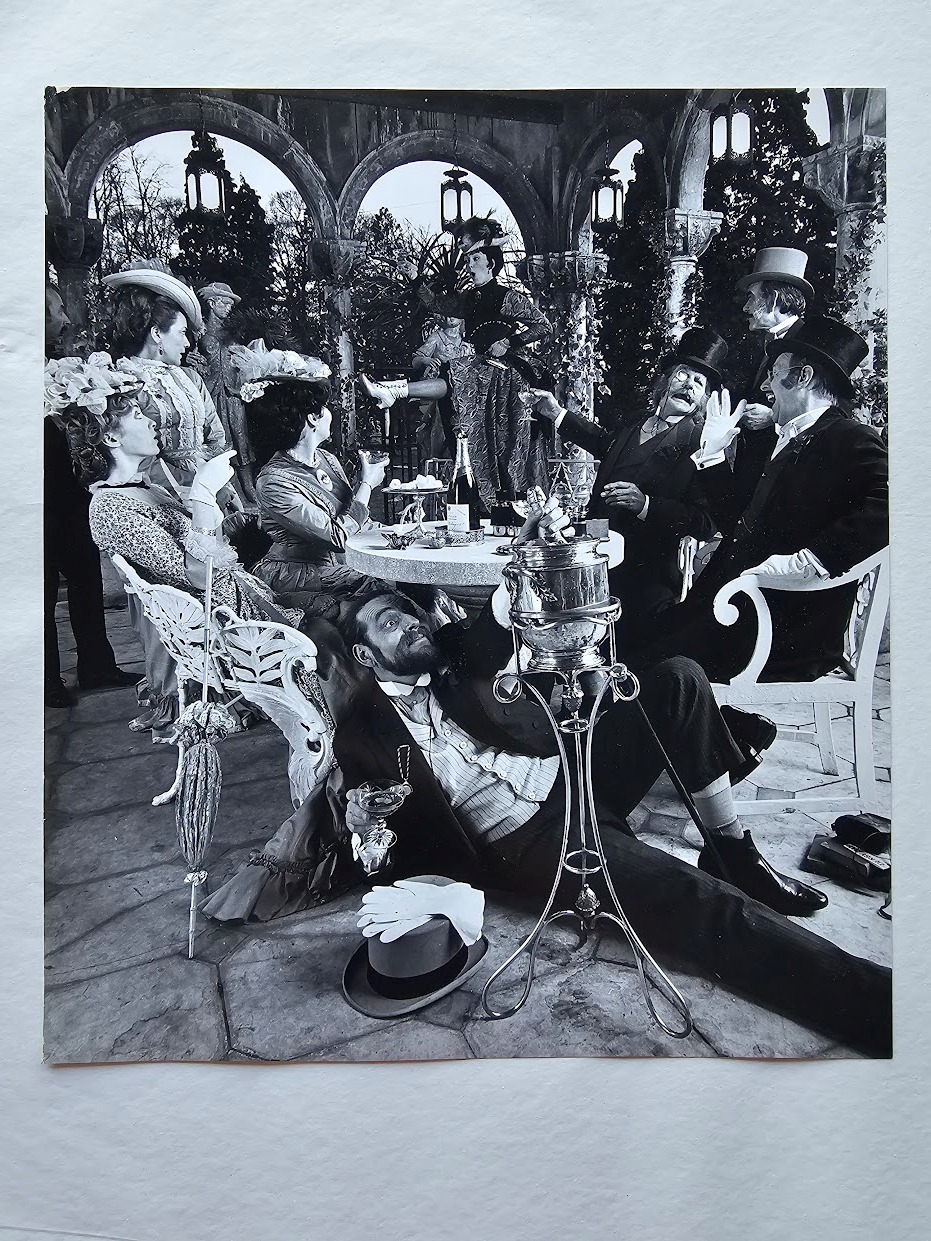Period costume champagne advert group scene, drunken people having a good time with one under the table by Michael Joseph