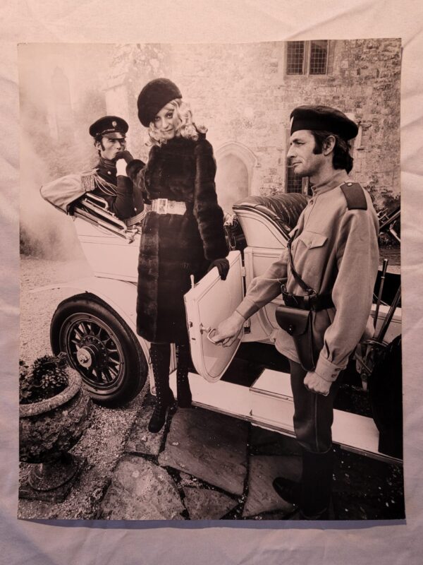 Fur to be fumbled in, advert from the sixties, sexy lady leaving car with army officer in front of château, by Michael Joseph