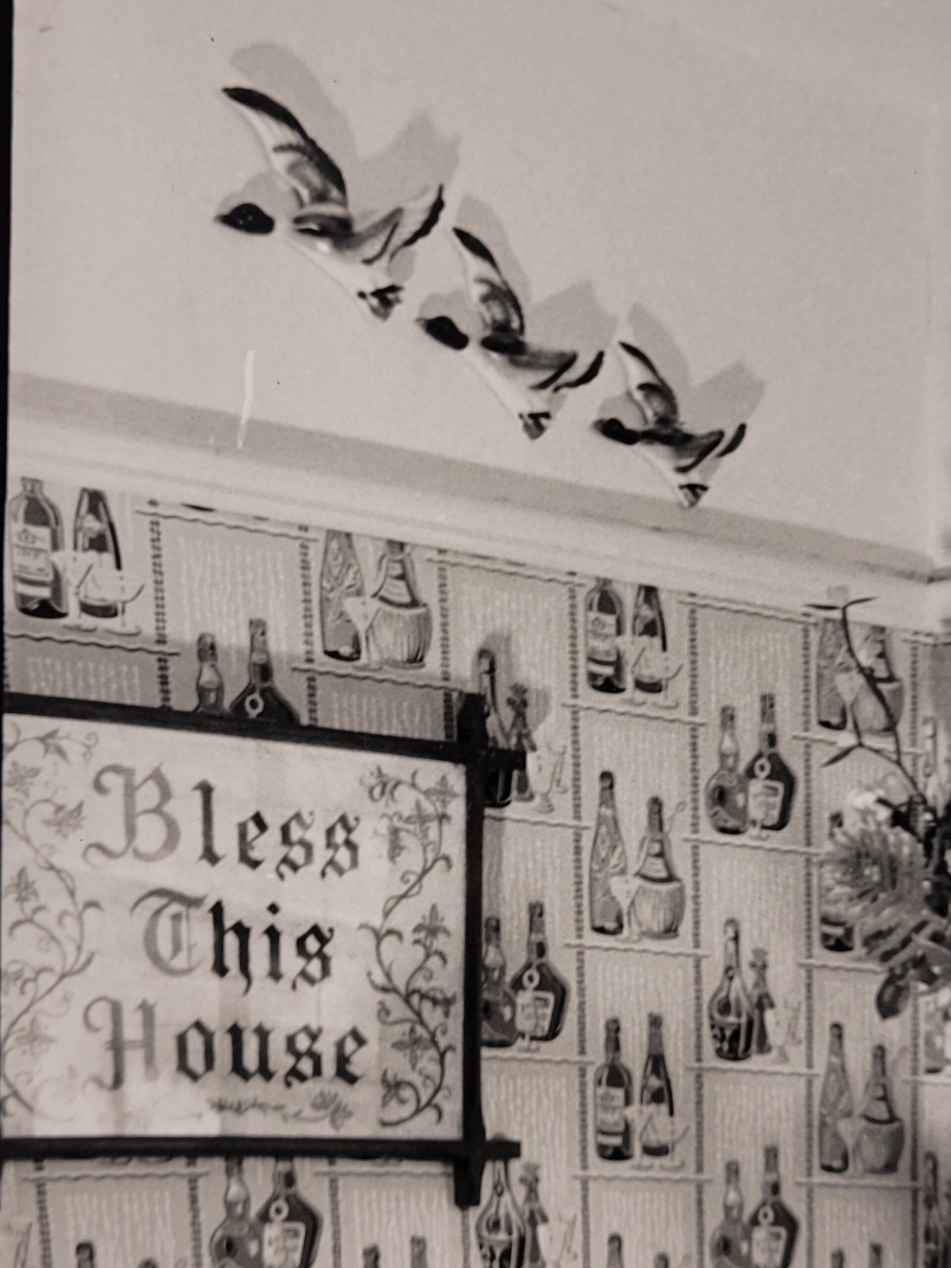 Family meal, housewife serving bangers and mash in curlers stereotypical british sixties household, by Michael Joseph