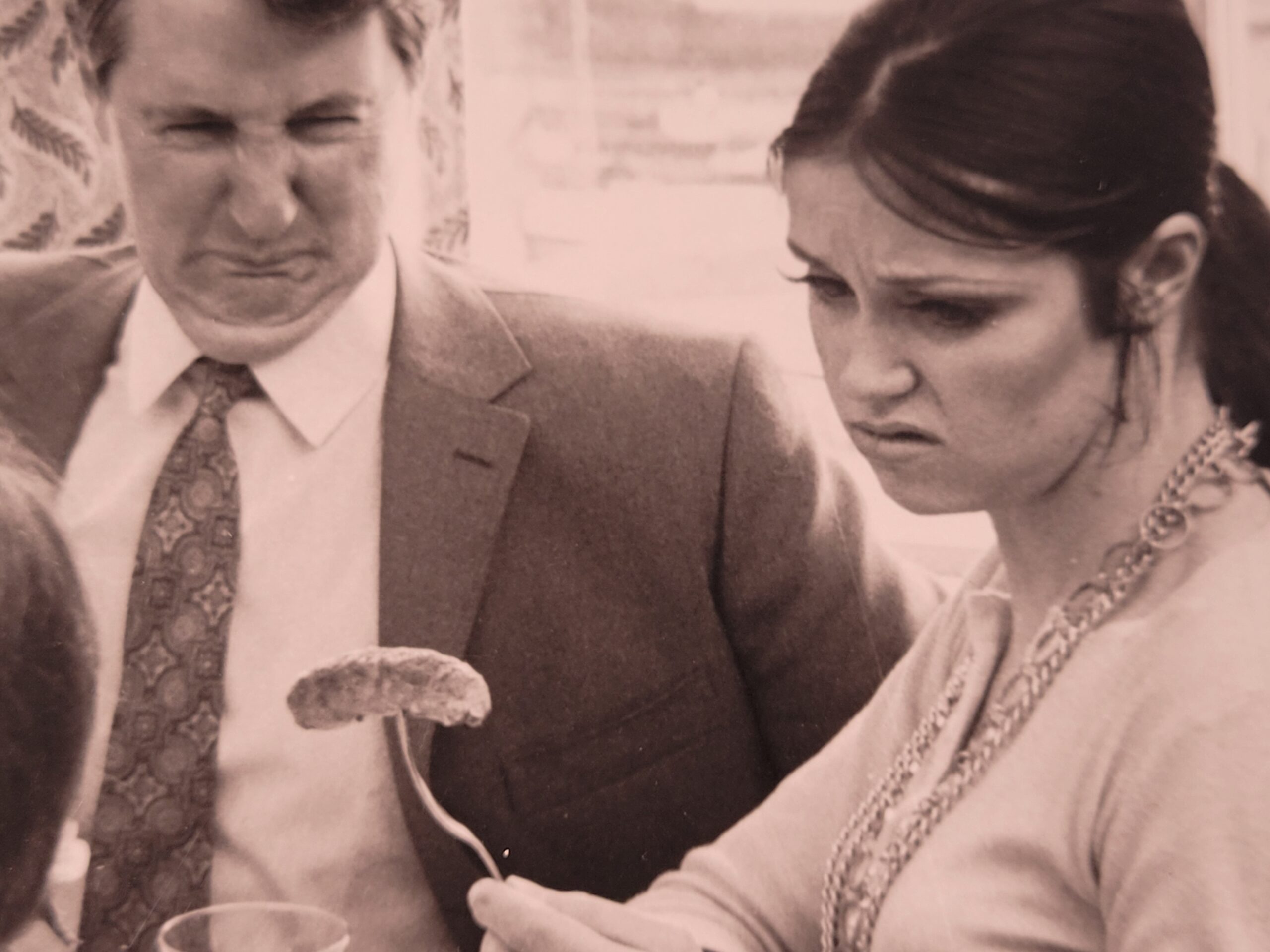 Family meal, housewife serving bangers and mash in curlers stereotypical british sixties household, by Michael Joseph