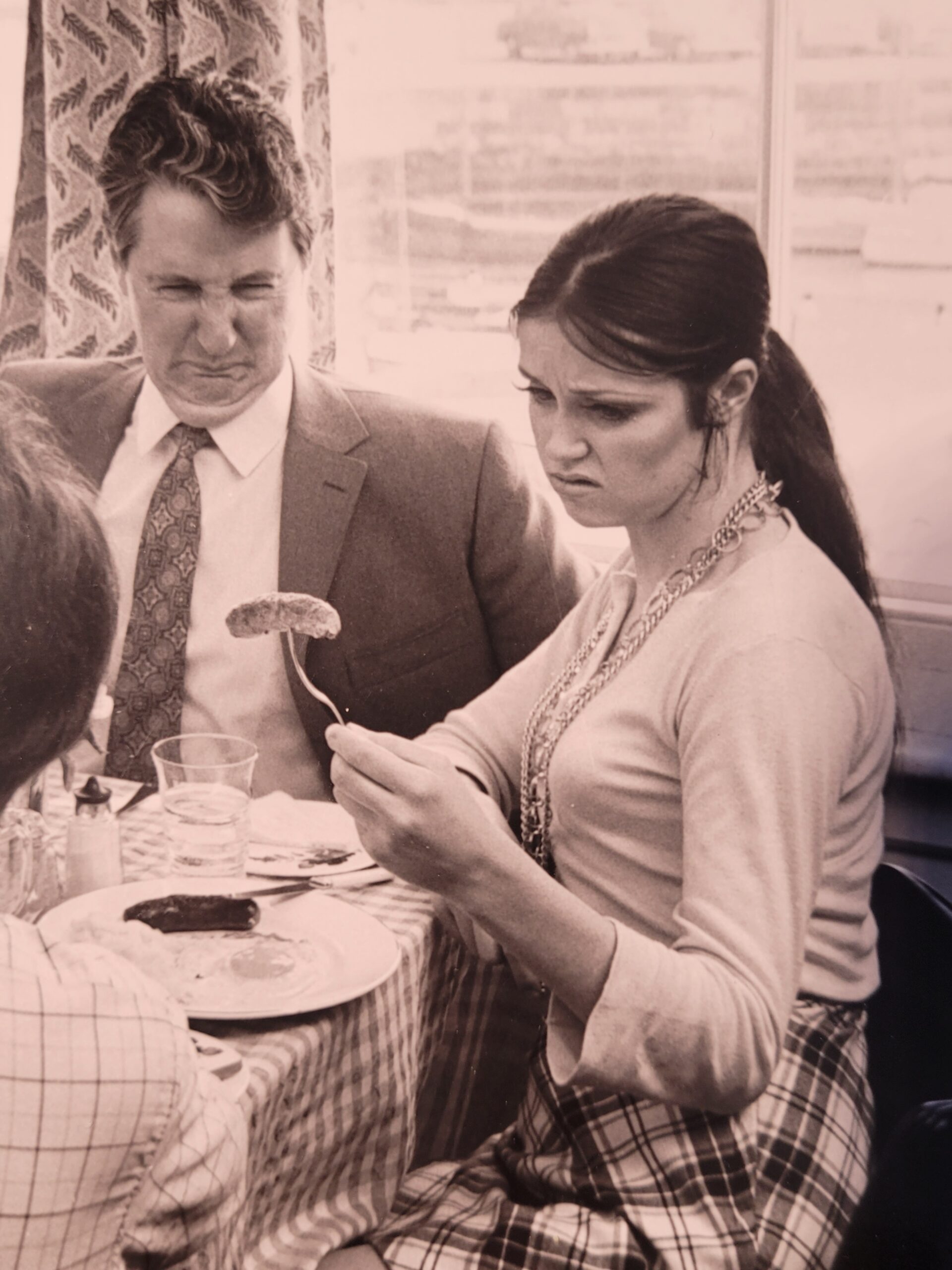 Family meal, housewife serving bangers and mash in curlers stereotypical british sixties household, by Michael Joseph