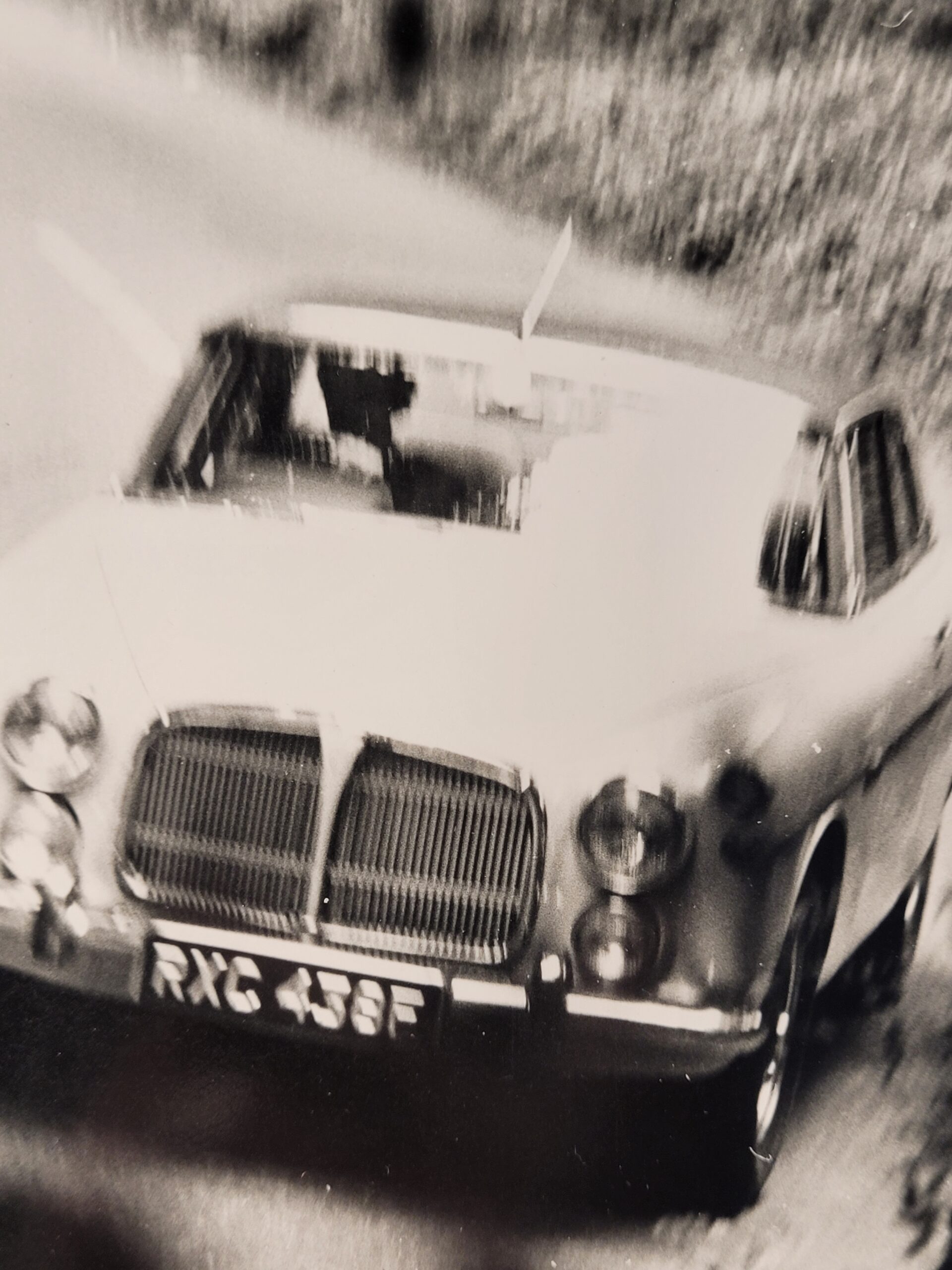 White car driving along a country lane, authentic darkroom photo in movement by Michael Joseph