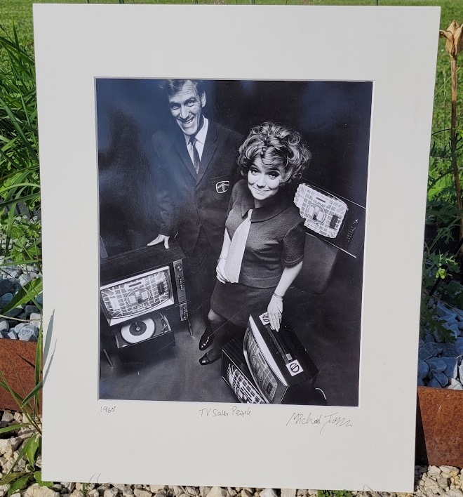 Sixties television sales people with several televisions, by Michael Joseph