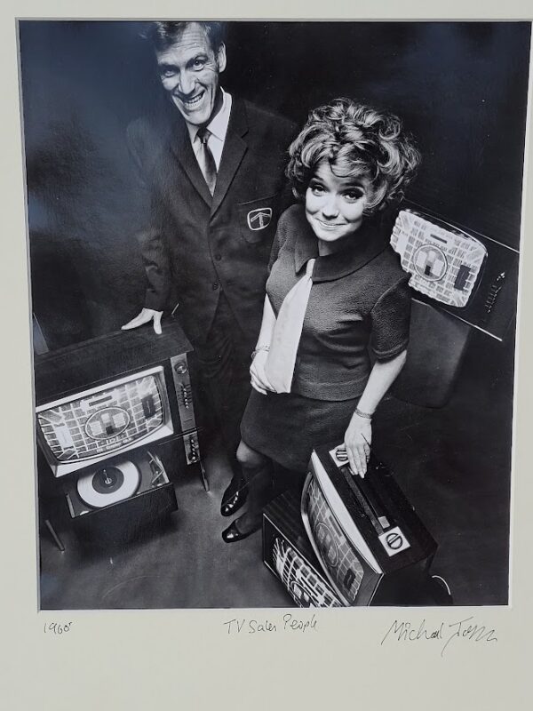 Sixties television sales people with several televisions, by Michael Joseph