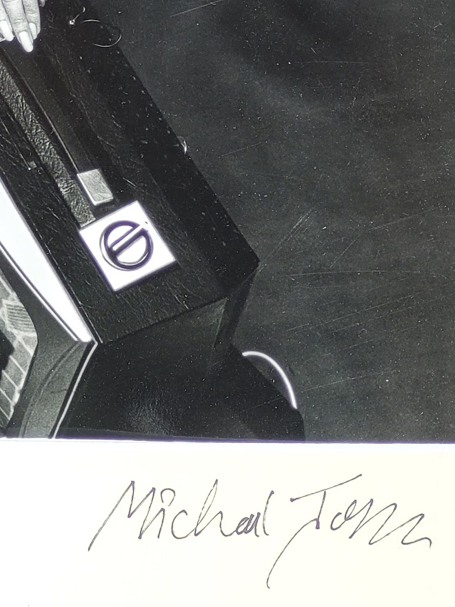 Sixties television sales people with several televisions, by Michael Joseph