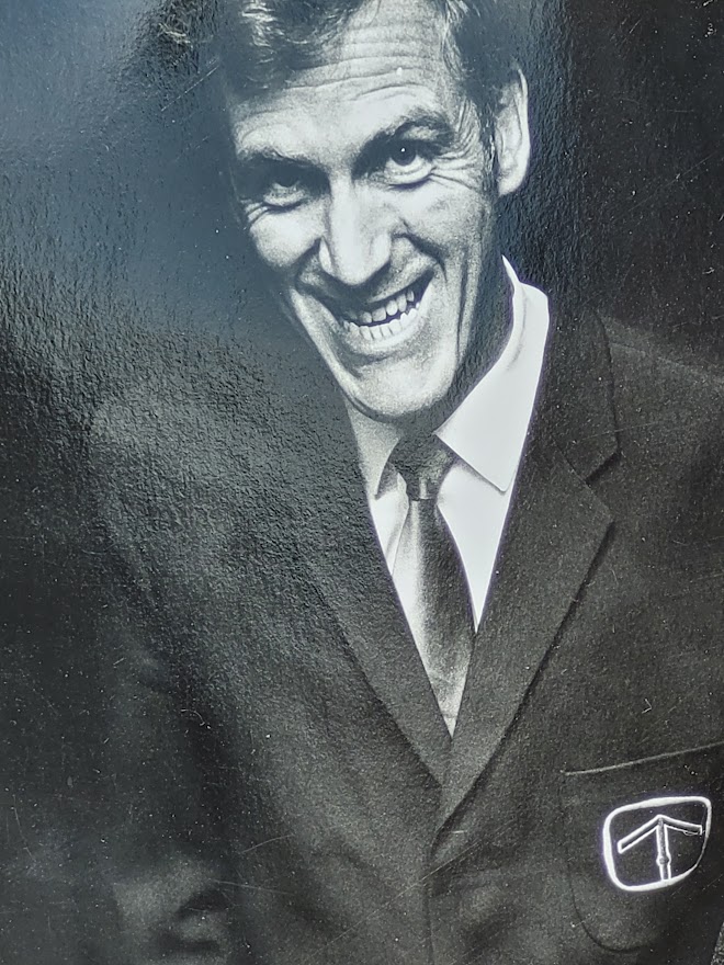 Sixties television sales people with several televisions, by Michael Joseph