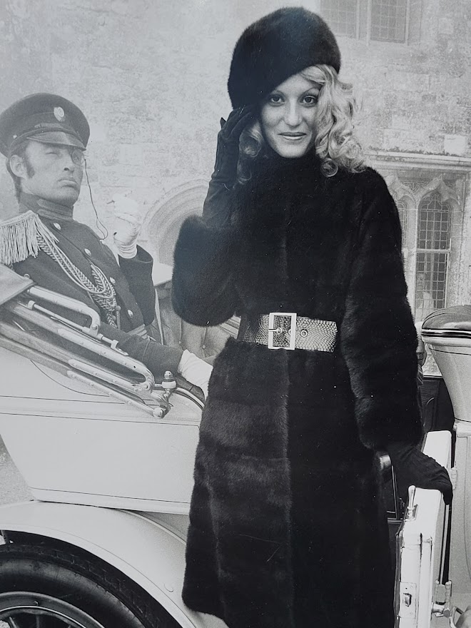 Brown-eyed blonde with fur hat and gestapo leaving car, seventies advert proof shot by Michael Joseph