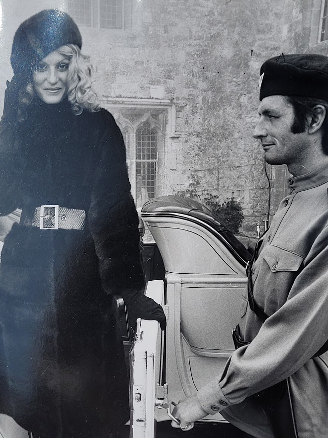 Brown-eyed blonde with fur hat and gestapo leaving car, seventies advert proof shot by Michael Joseph