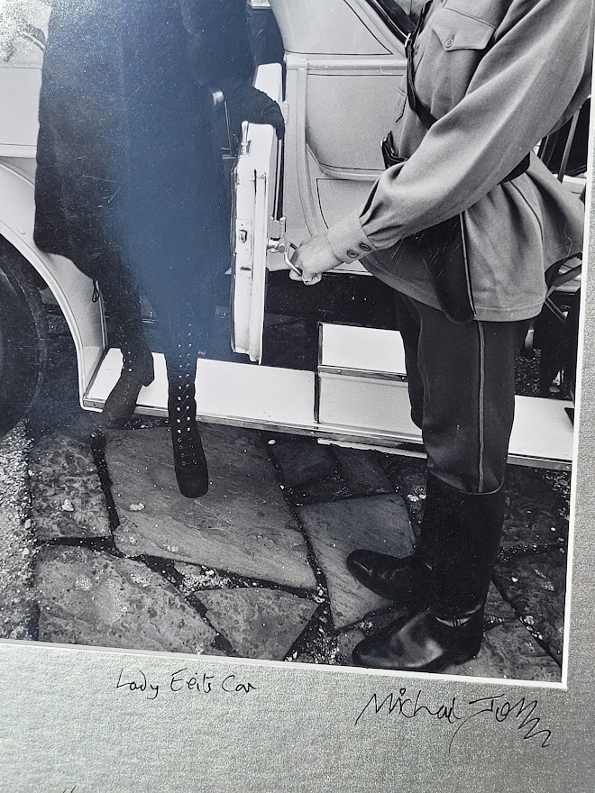 Brown-eyed blonde with fur hat and gestapo leaving car, seventies advert proof shot by Michael Joseph