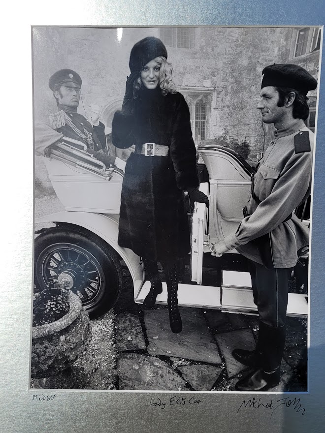 Brown-eyed blonde with fur hat and gestapo leaving car, seventies advert proof shot by Michael Joseph