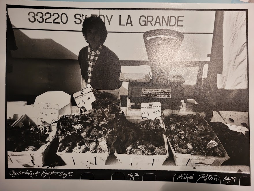 Oyster lady, Eymet market stall in South-west France, high contrast black and white print, by Michael Joseph
