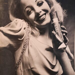 Smiley blonde holding her Fry chocolate bar suggestively, Solo Power Collection casting out-take by Michael Joseph