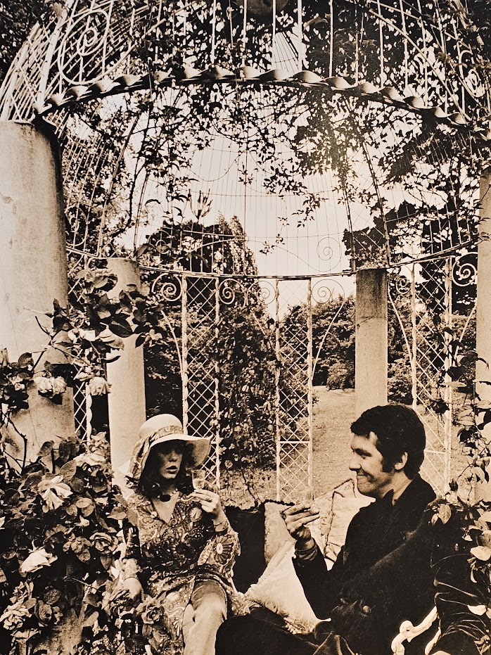 Cointreau advert, couple in folie pergola, metal structure with climbing rose vegetation and cast iron chairs by Michael Joseph