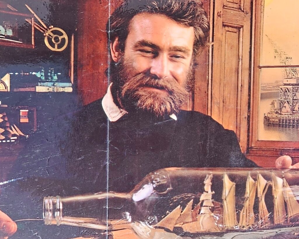 Shipbuilding and Smirnoff... leave me breathless! Vodka advertisement from the 1970s, bearded modelmaker and sexy blonde by Michael Joseph