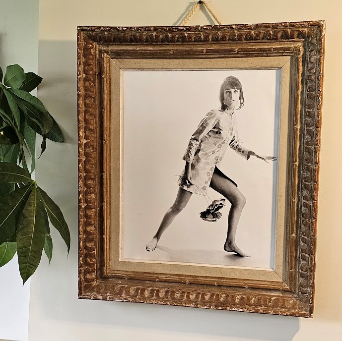 Jovial model, barefoot with big flowers, authentic darkroom print by Michael Joseph in an upcycled copper tint wooden frame
