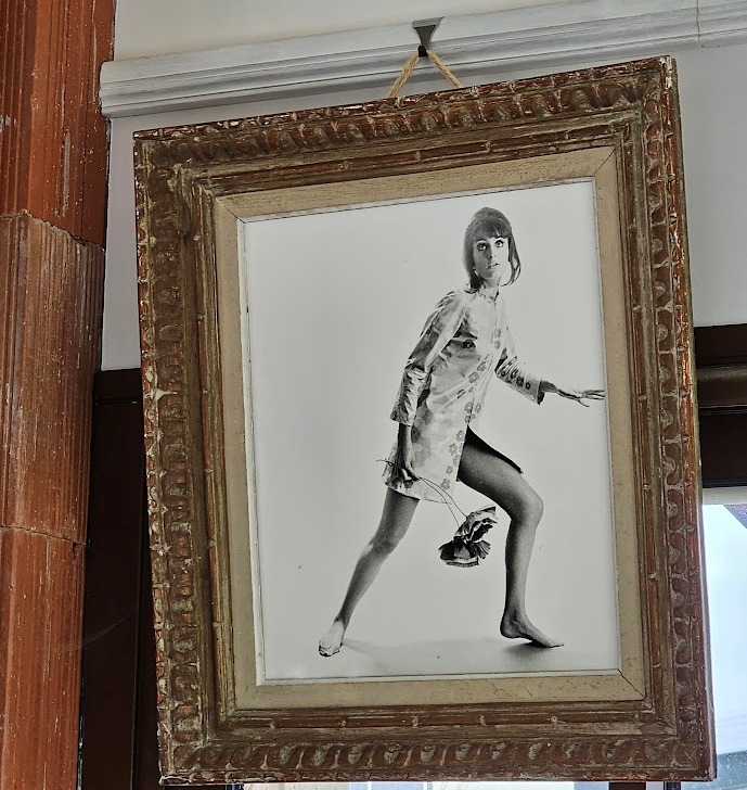 Jovial model, barefoot with big flowers, authentic darkroom print by Michael Joseph in an upcycled copper tint wooden frame