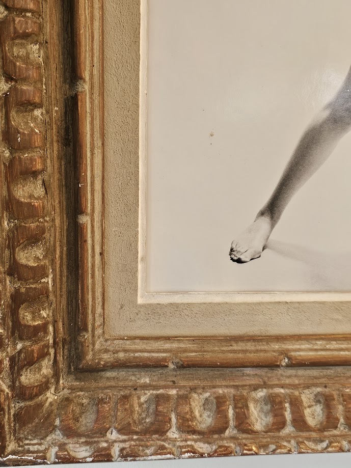 Jovial model, barefoot with big flowers, authentic darkroom print by Michael Joseph in an upcycled copper tint wooden frame