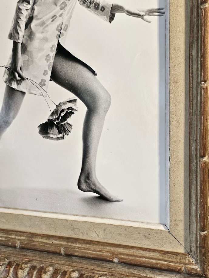 Jovial model, barefoot with big flowers, authentic darkroom print by Michael Joseph in an upcycled copper tint wooden frame