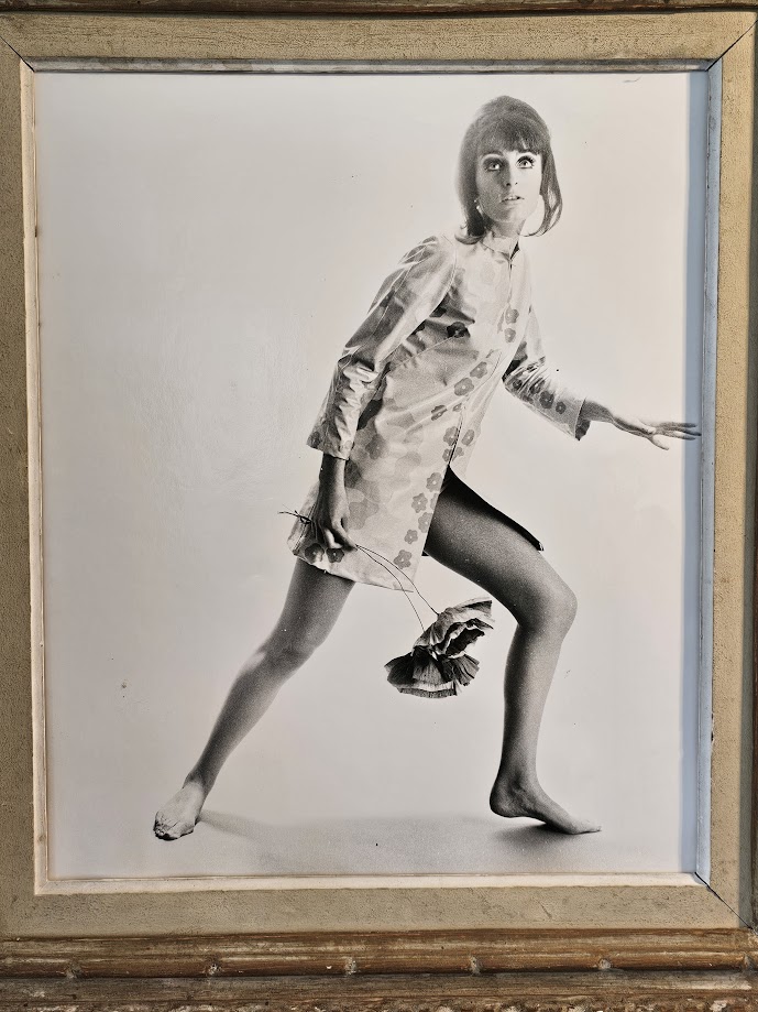 Jovial model, barefoot with big flowers, authentic darkroom print by Michael Joseph in an upcycled copper tint wooden frame