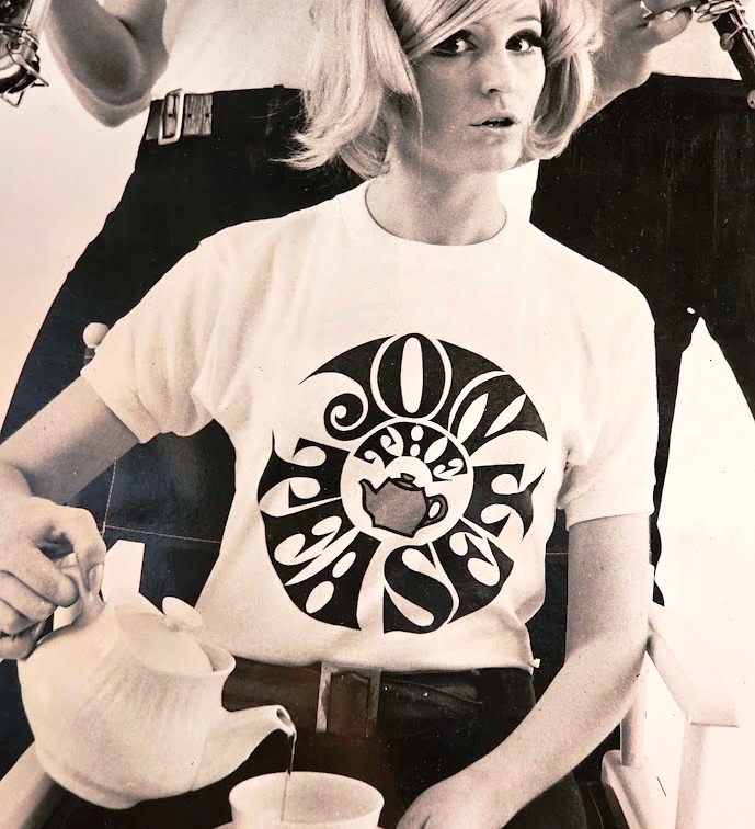 Join the Tea Set blonde pouring tea, guys clarinette and Saxophone, tea-set t-shirts by Michael Joseph, silver and peacock-blue floral delight frame