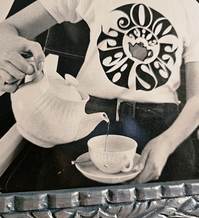 Join the Tea Set blonde pouring tea, guys clarinette and Saxophone, tea-set t-shirts by Michael Joseph, silver and peacock-blue floral delight frame