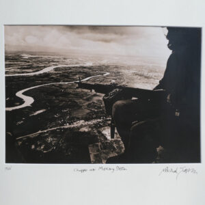 Chopper over McKong Delta, South Vietnam, soldier poised in army helicopter by Michael Joseph