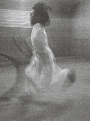 South Vietnam street girl playing with hoop just before dusk curfew bell tolls by Michael Joseph