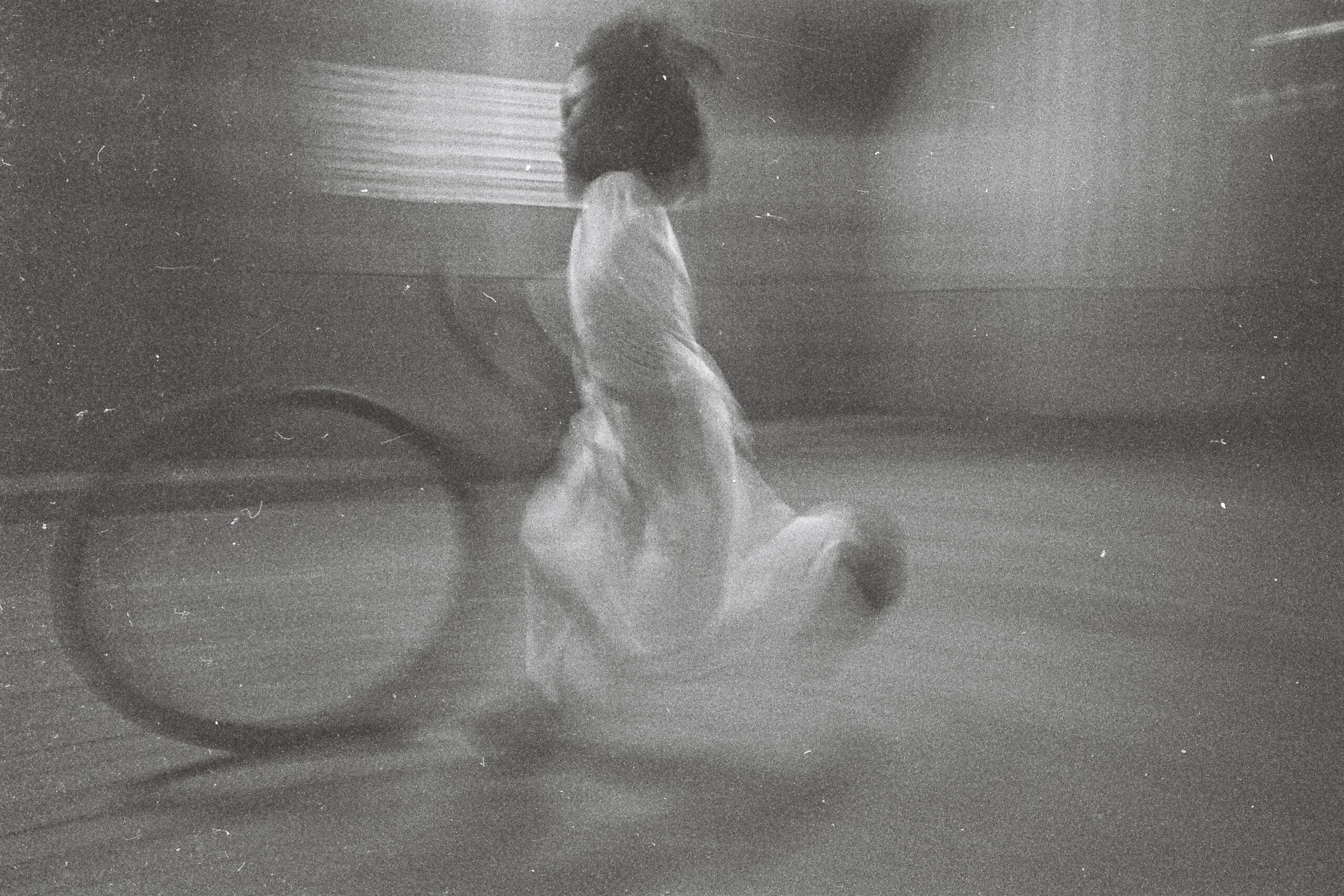 South Vietnam street girl playing with hoop just before dusk curfew bell tolls by Michael Joseph