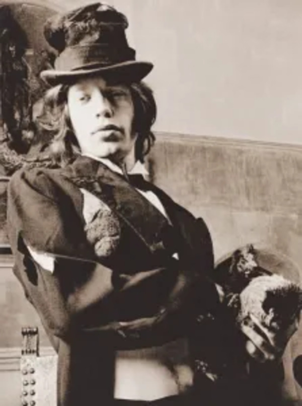 Mick Jagger holding a chicken