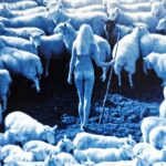 A blue-toned image of a nude woman holding a staff surrounded by sheep